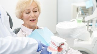 older woman consulting with dentist