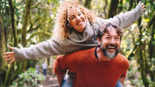 a mature couple having fun and smiling with dentures  