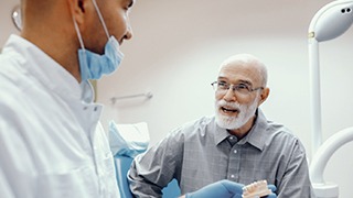 elderly man at a dental implant consultation 