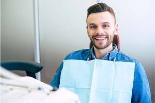 Man with dental bridge in The Colony smiling at the dentist