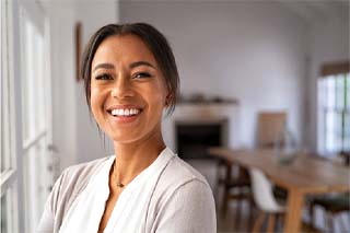 Woman with dental bridge in The Colony smiling