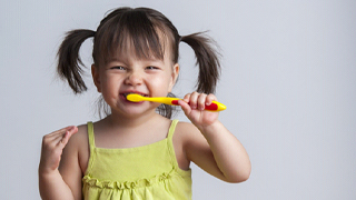 toddler brushing their teeth