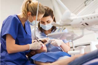 Dentist in The Colony working on patient