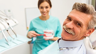 a patient smiling about the benefits of dentures