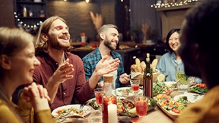 a man with dentures eating a healthy meal with friends