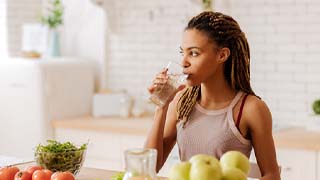 woman drinking water and having a healthy diet