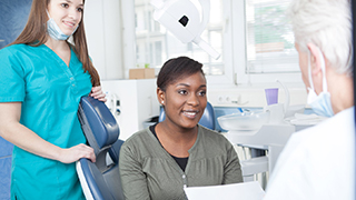 Emergency dentist in the Colony and patient discuss cost of emergency dental care