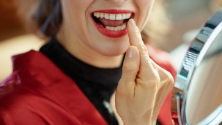 Woman pointing to her tooth