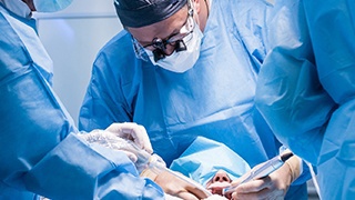 dentists performing dental implant surgery 
