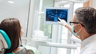 dentist showing a patient their dental X-rays 