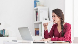 woman chewing on pencil