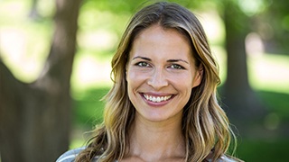 Woman outdoors smiling brightly