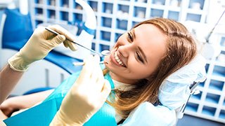 patient smiling about cost of root canal in The Colony