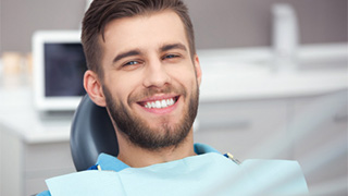 Man smiling in dentist’s chair