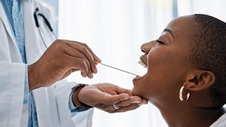 Dentist examining a patient’s mouth