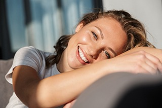 young woman smiling after getting teeth whitening in The Colony