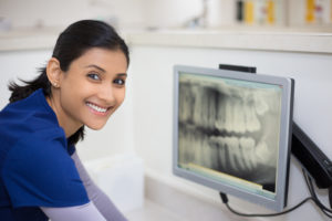 technician sitting at imaging device