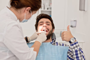 man smiling thumb up dental visit