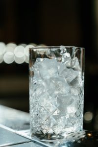 Glass full of ice on counter