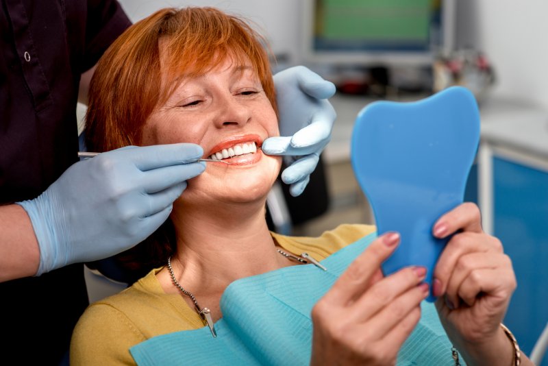 woman smiling after getting dental implants in The Colony