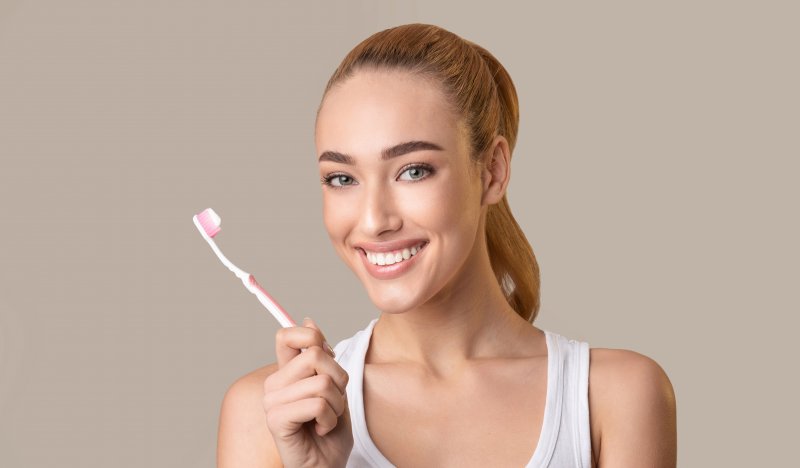 Woman smiling with a toothbrush