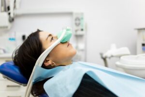 Patient in dentist's chair receiving laughing gas.